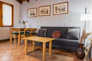 a living room with a couch and a table at Villa Sanziana in Menaggio