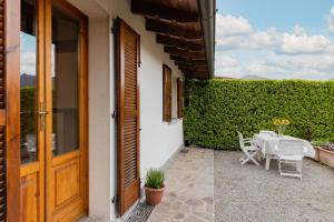 a patio with a table and chairs next to a building at Villa Sanziana in Menaggio