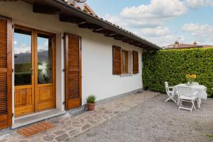 a patio with a table and chairs next to a building at Villa Sanziana in Menaggio