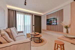a living room with a couch and a table at Terra luxury apartments in Preveza