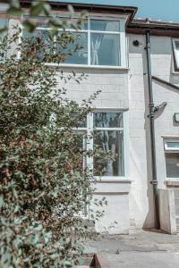 a house with a window with a plant in it at An entire 3 Bedroom house in Beeston United Kingdom in Beeston