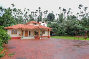 a house with a basketball hoop in front of it at Nandanam Villa in Kaniyāmbetta