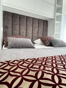 a bedroom with a large bed with a large headboard at Sequeira Arantes Casa 2 in Terras de Bouro