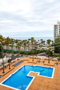 a view of the pool at a resort with palm trees at Juanvi's Corner in Costa de Adeje