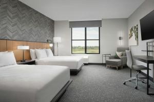 a hotel room with two beds and a desk at TownePlace Suites by Marriott Bozeman West in Bozeman +64 photos
