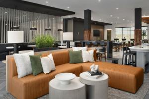 a living room with a couch and a restaurant at TownePlace Suites by Marriott Bozeman West in Bozeman