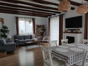 a living room with a table and chairs and a tv at Ara Chalet in Bran
