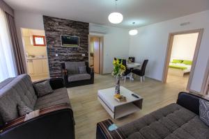 a living room with two couches and a table at Apartments Matkovic Lux in Sutomore