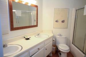 a bathroom with a sink and a toilet and a mirror at Sierra Park Villas #89 in Mammoth Lakes