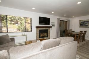 Una sala de estar con un sofá y una chimenea. en Mammoth Ski & Racquet Club #127, en Mammoth Lakes