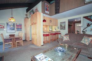 a living room with a couch and a table at Discovery 4 142 Loft in Mammoth Lakes