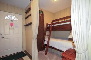 a bedroom with two bunk beds and a white door at Discovery 4 137 in Mammoth Lakes +6 photos