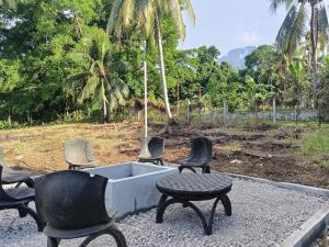 a group of chairs and a tub with a table at The CozyNest Camiguin Homestay in Mambajao