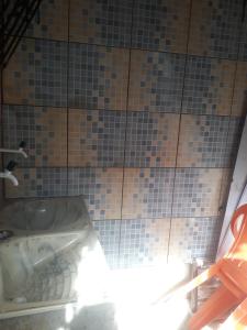 a tiled bathroom with a tub and a sink at Casa salinas prox orla in Salinópolis