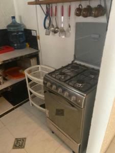 a stove in a kitchen with utensils at Casa En Flandes ARAGON 1 in Flandes