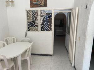 a dining room with a white table and chairs at Casa En Flandes ARAGON 1 in Flandes