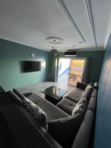a living room with a couch and a table at Ammour Apartment in Chefchaouene