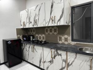 a kitchen with a sink and a counter top at Supreme Apartments in Nawānpind