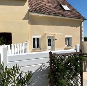 a white fence in front of a house at Gîte Les Sassiers in Saint-Firmin-sur-Loire