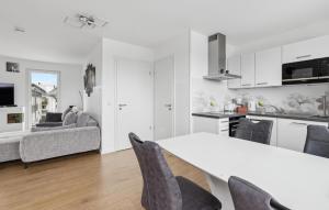a white kitchen and living room with a table and chairs at 5 Residenz Panoramablick in Winterberg