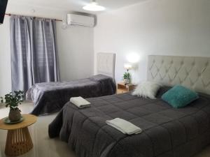 a bedroom with two beds with towels on top of it at Departamentos Aimogasta Vientos in Arauco