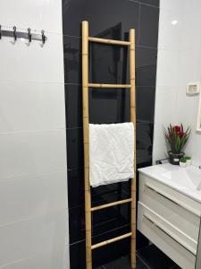 a bathroom with a wooden towel rack next to a sink at מול הגלבוע Escape Suite in Gid‘ona +18 photos