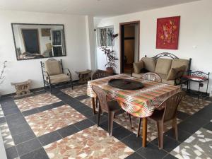 a living room with a table and chairs at Touty in Dakan