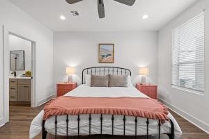a bedroom with a large bed with two night stands at Voodoo House KING Bed Garage Fast WiFi 65 Tv in Lafayette