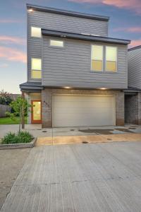 a house with a garage in front of it at Voodoo House KING Bed Garage Fast WiFi 65 Tv in Lafayette