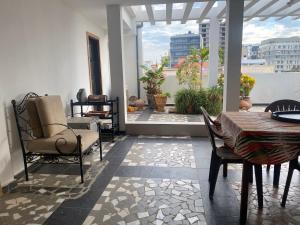 a room with a table and chairs on a balcony at Touty in Dakan