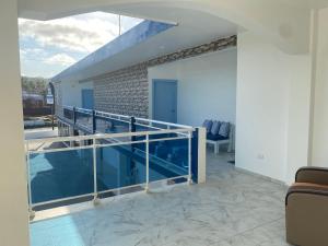 a balcony with glass railing in a house at Hotel Down Town Cabrera in Cabrera