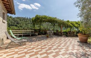 a patio with a chair and a table and trees at Awesome Apartment In Castelfranco Piandiscò in Castelfranco Piandisco +18 photos