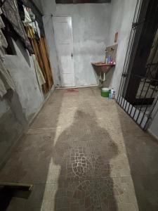 a shadow of a person on a tiled floor in a bathroom at Casa Aconchegante COP30 in Ananindeua