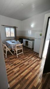 a room with a kitchen with a table and a refrigerator at Lavalle in Santiago del Estero