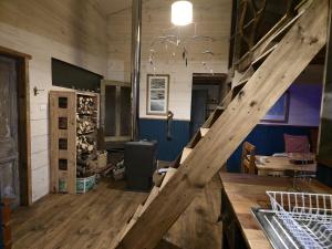 a wooden staircase in a room with a wine cellar at Casa Ko in La Ensenada