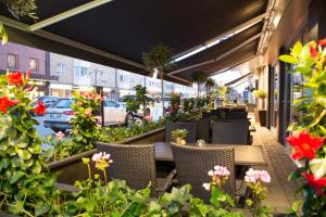 a patio area with tables, chairs, and umbrellas at Best Western Plus Savoy Lulea in Luleå