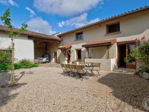 a patio with chairs and a table in front of a house at Évasion Champêtre avec Spa, Activités ludiques et Confort moderne - FR-1-496-310 in Saint-Cyr-les-Vignes