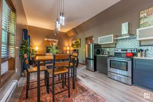a kitchen with a table and a dining room at Downhill Lodge Condominium in Lake Placid