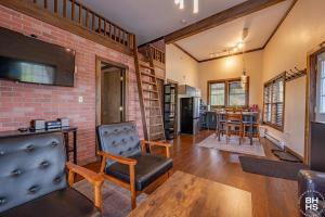 a living room with a chair and a brick wall at Downhill Lodge Condominium in Lake Placid