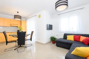 a living room with a couch and a table at Apartments Salona in Trogir