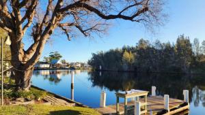 a view of a lake with a wooden dock at A Slice Of Paradise in Sussex Inlet