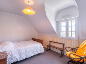 a bedroom with a bed and a chair and a window at Maison Néo-Bretonne 6 pièces avec jardin à Carnac - 9 personnes - FR-1-477-264 in Carnac