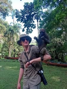 a man with a camera and a monkey on his arm at hospedaje Casa Jaguar in Macedonia +41 photos