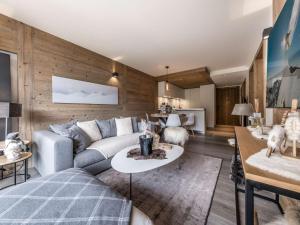 a living room with a couch and a table at Appartement moderne Courchevel 1550, 4 personnes, parking, wifi - FR-1-631-234 in Courchevel