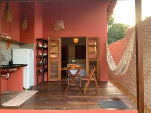 a kitchen with a hammock in the middle of a room at Canto Carauari Pousada in Alter do Chao