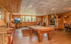 a pool table in a room with wooden walls at Pop A Bear in Pittman Center