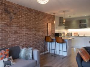 a living room with a couch and a brick wall at Lancaster City Apartment in Lancaster +7 photos