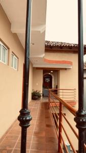 a hallway of a building with a railing and a staircase at HOTEL PLAZA VASCO in Pátzcuaro
