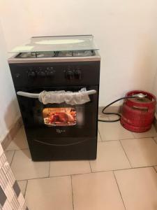 a black oven with a fire inside of it at Torobali IMMO Studio 1 -Cozy Furnished Studio - City Center Bamako- Ideal for short Stays in Bamako