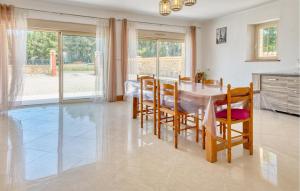 a kitchen and dining room with a table and chairs at Charmante Maison Avec Piscine in La Douze